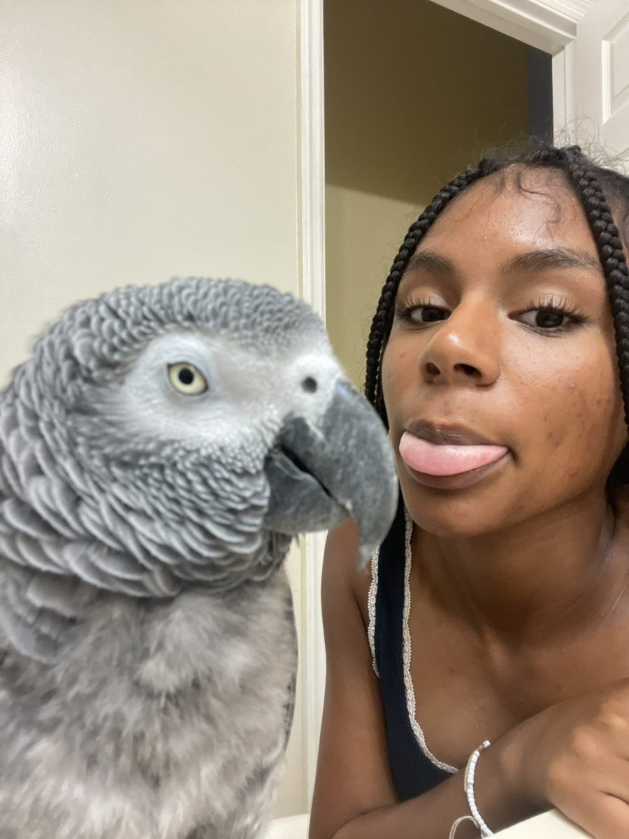 Sophomore Jaysleen Richards poses next to her pet parrot, Peetee. While Peetee is a memorable and beloved pet to Richards, she often will bite when upset.