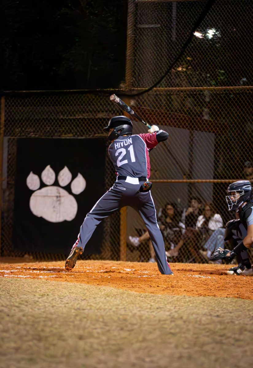 Sophomore Maddox Hivon (#21) loading up to swing his bat and make contact with the baseball.