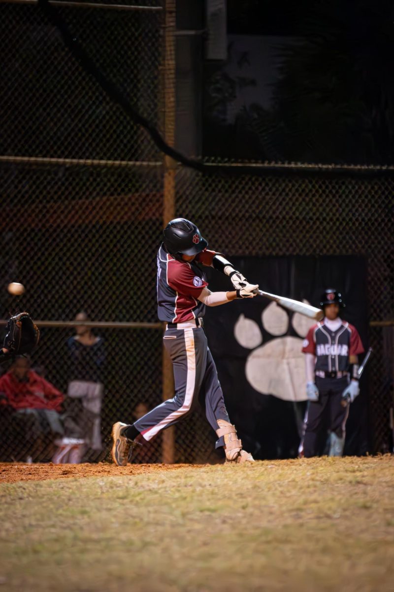 Sophomore Liam Caban (#3) swinging his bat and fouling off the ball as he fights to get a hit.
