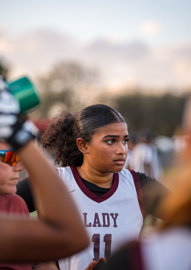Junior Jada Cooper on the Lady Jags flag football team listening to her coach as she is telling the game plan.
