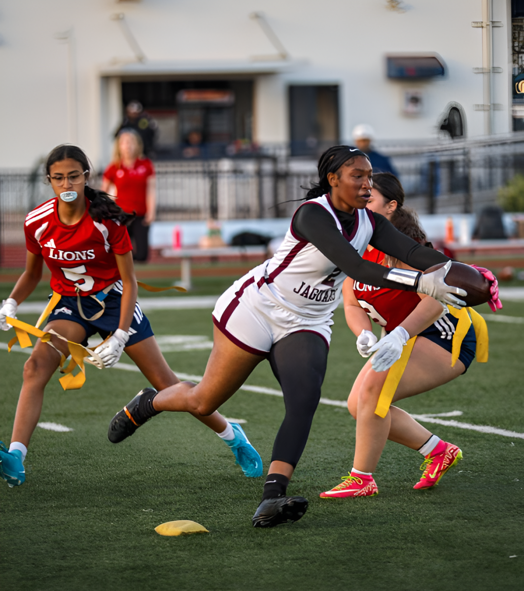 Senior Brianna Barbee running with the football in an attempt to run past the other team and make a touchdown. Yet, her flag got pulled, so the play ended.

