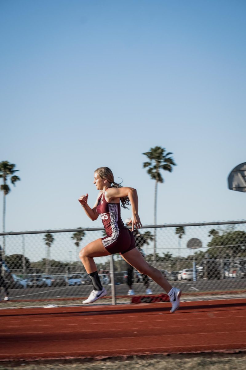 Senior Lauren Pfeiffer sprints using power in each step she takes.
