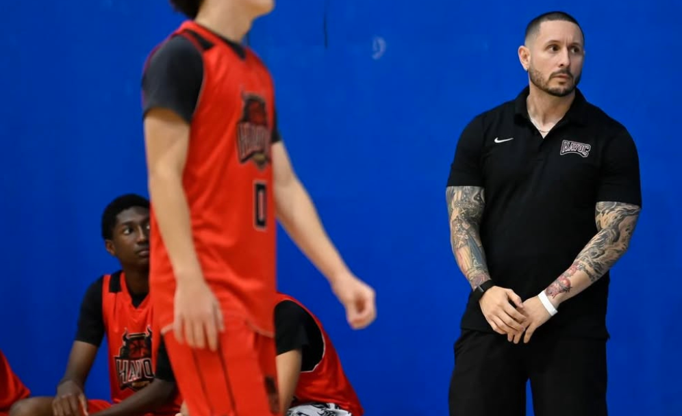 Garcia (right) stands on the sideline with his travel basketball team. He turns his passion and experience of basketball into something real by coaching student-athletes with their skills. Garcia plans on expanding this with his teaching business.