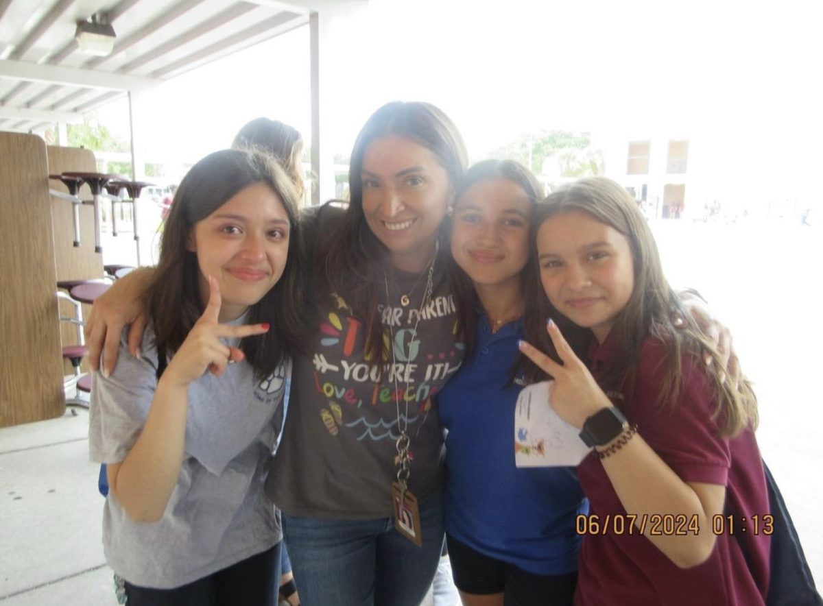 Photo highlights (from left to right) Carla Duran, Ms. Franco, Alejandra Gomez Velasquez, and Ixchel Cruz as they take a group photo in middle school to show off their close bond.