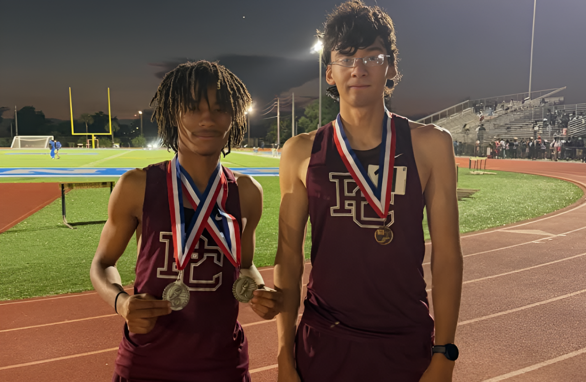 Juniors Adam Stewart (left) standing alongside Gian Carlo De Bastos (right) with their medals from the BCAA championship posing for the camera.