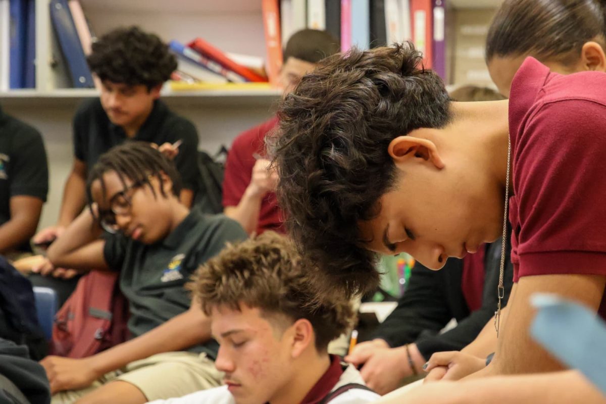 Junior, Fabrizio Alcazar, is front in focus as he closes his eyes during First Priorities opening prayer.