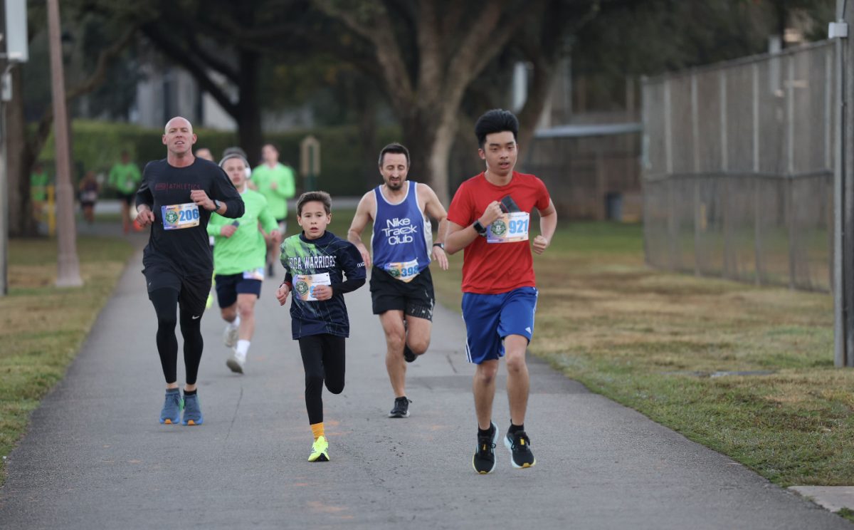 James Zhang runs neck and neck with other runners during the run at Central Park in plantation.
