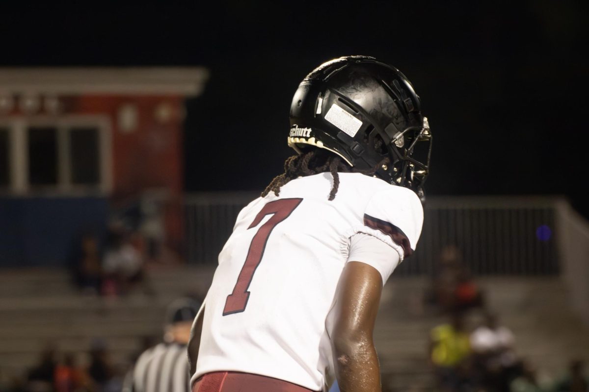Junior Jahsai Juste (#7) standing on the football field during a game anticipating the next play. Showing his determination for a sport that is not just track. 