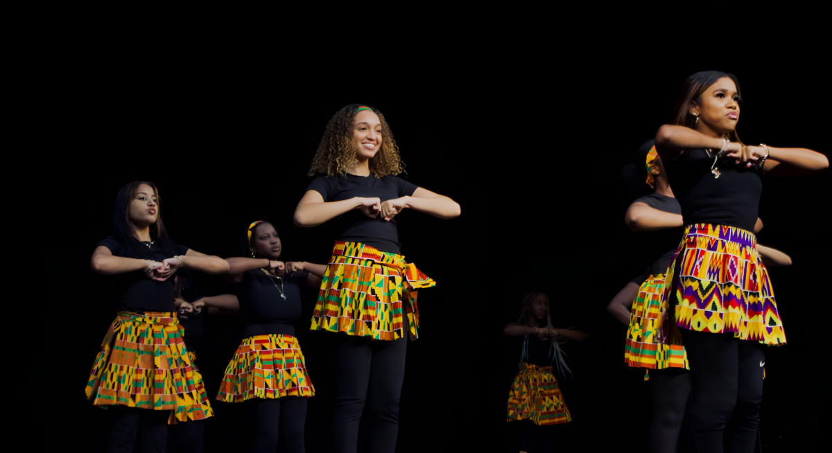 The Jaguars step team performing on the stage, using cultural empowerment with every step.