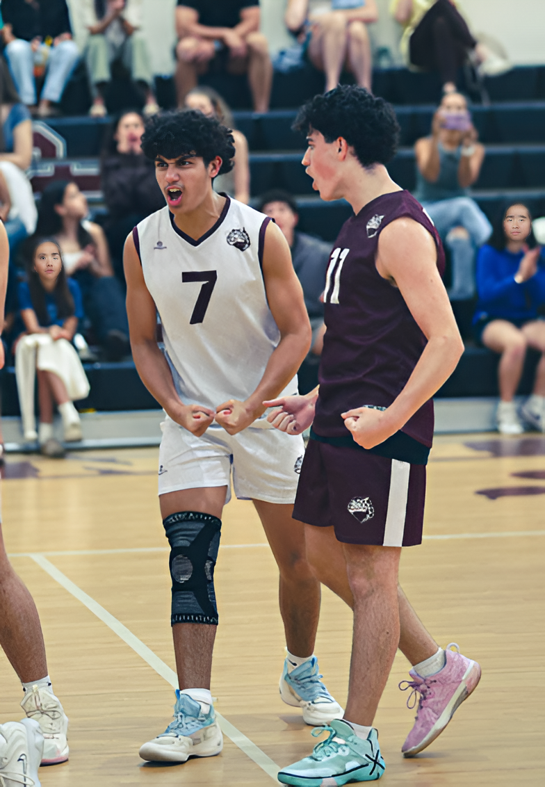 Sophomore Noah Reynolds (#7) celebrates with his teammate, senior Gerald Cabrera (#11) after getting the point for his team to win the match.