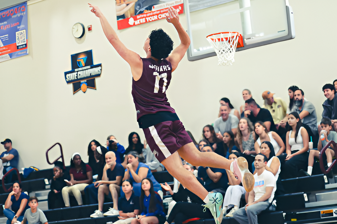 Senior Gerald Cabrera (#11) jumping in the air to spike the ball to kick off the Jaguar's volleyball home game.
