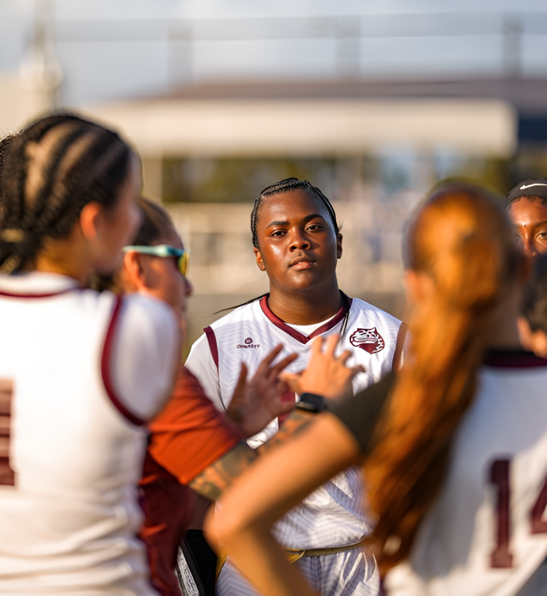 Sophomore Kylee Edwards stands with her teammates as they listen to their coach tell them the game plan.