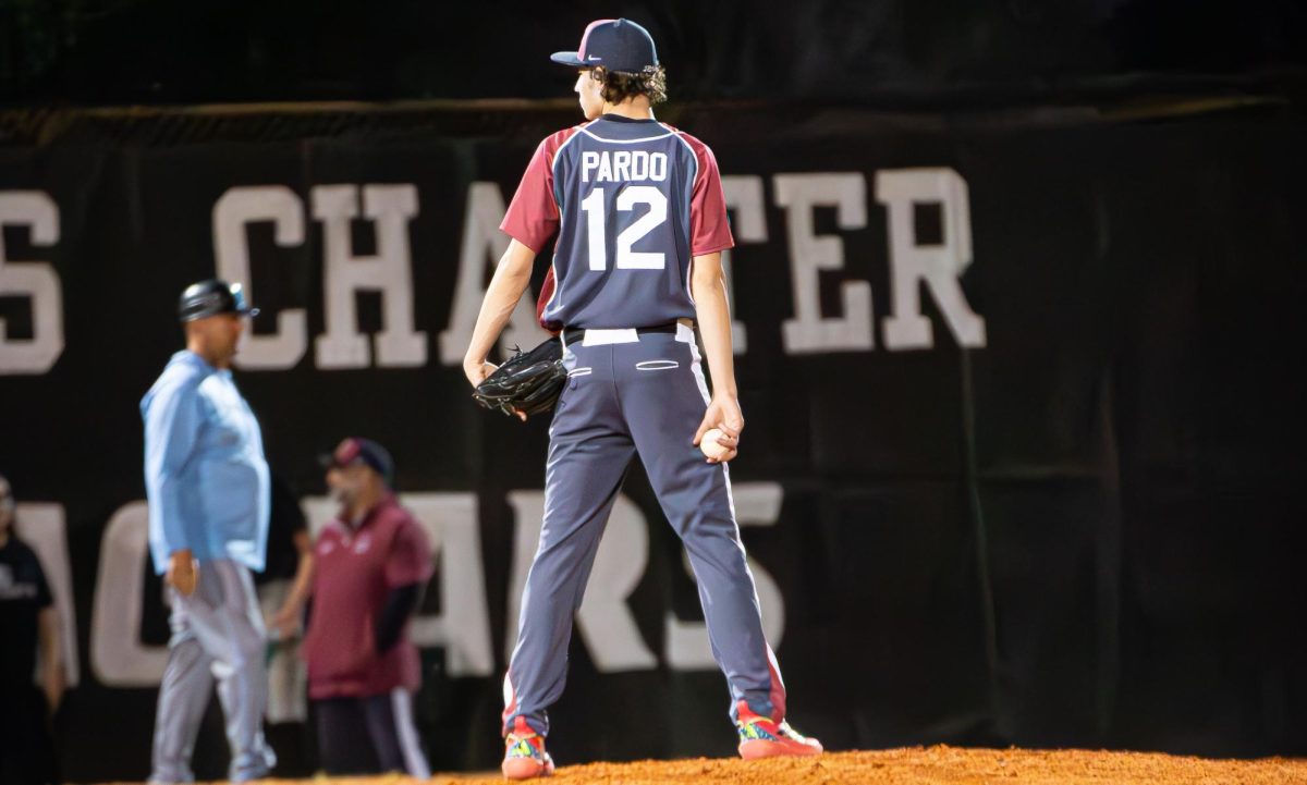 Junior Ashton Pardo watching the catcher before he throws the pitch to see what pitch he should throw.
