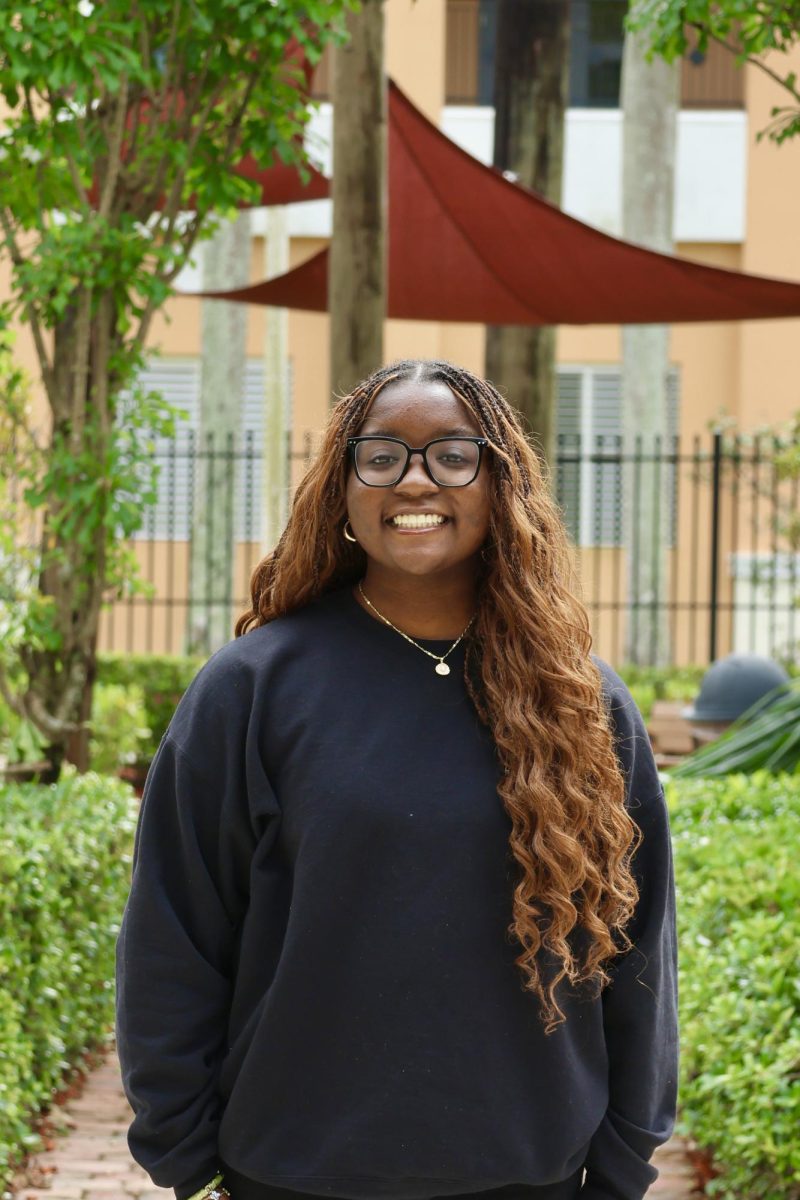 Sophomore Malia Nortelus smiling at the camera for her CHAT staff picture.