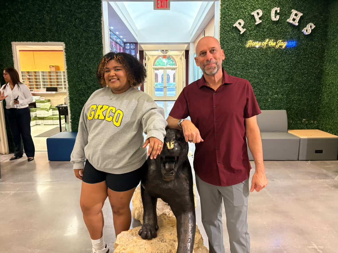 Juliana Duperval and Principal Bayer posing in front of the Jaguar statue. During the bell ringing ceremony, when the senior is called on they fist pump the Jaguar and then ring the bell. 