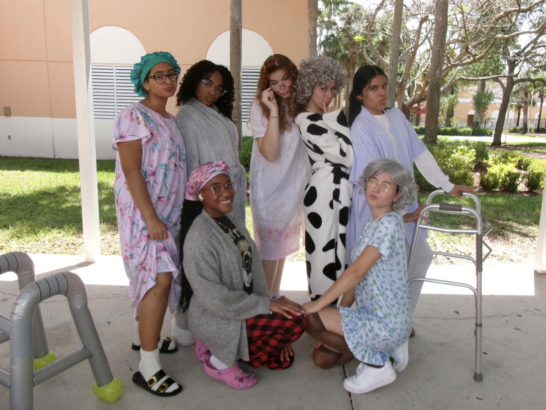 Kaitlyn Oramas and her friends stand in their senior citizen outfits, celebrating senior year and their friendships.