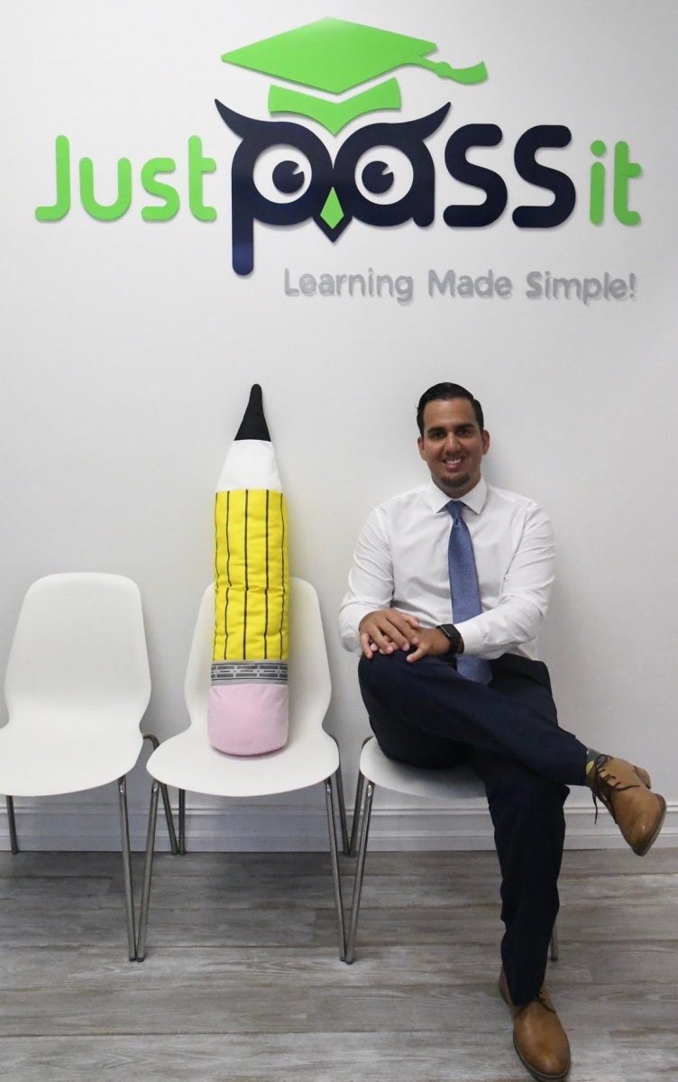Nelson Garcia sits inside the Just Pass It tutoring center, which he founded to help students prepare for exams and strengthen classroom skills.