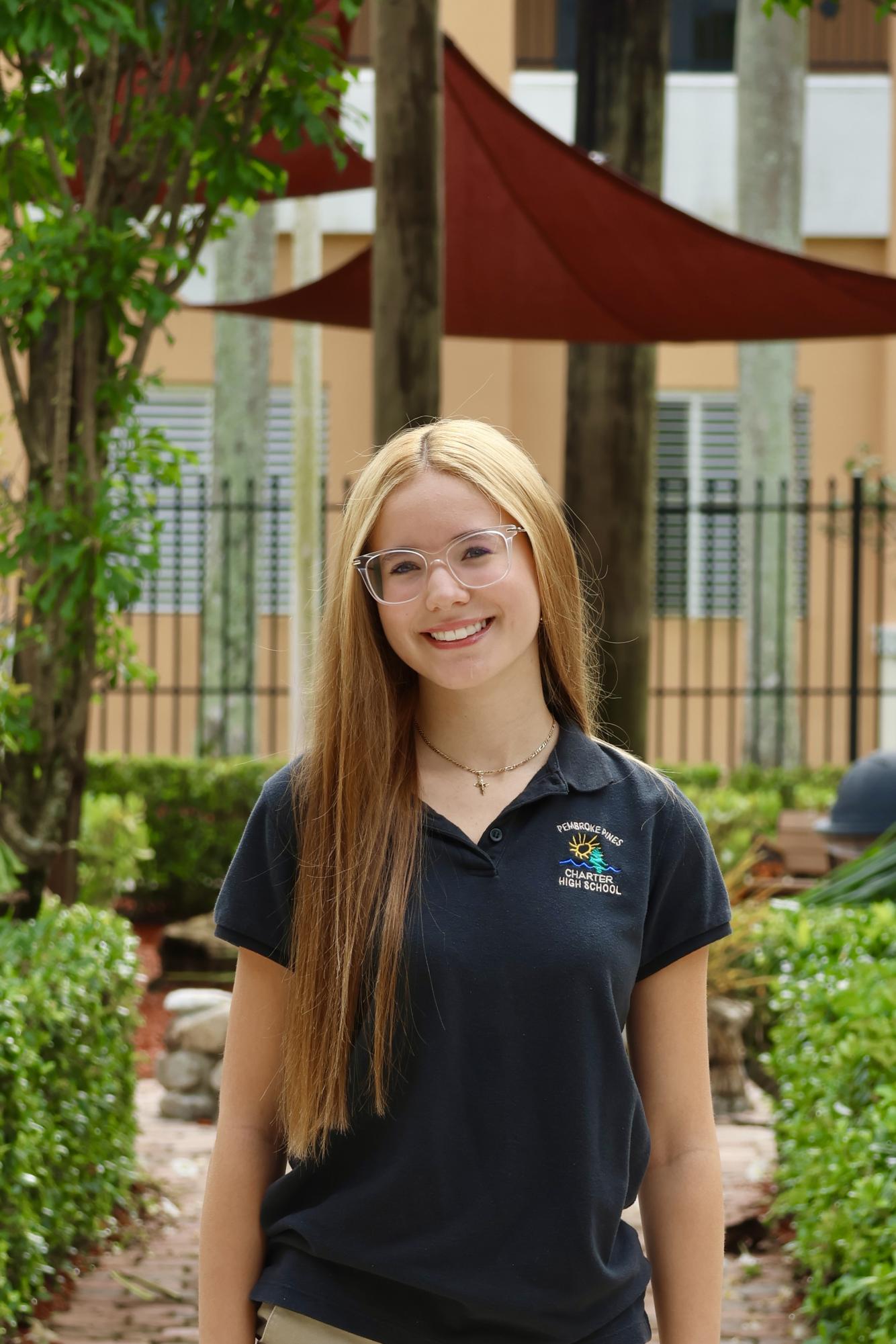 Senior Janeyliz Baez smiling at the camera for her CHAT staff picture.