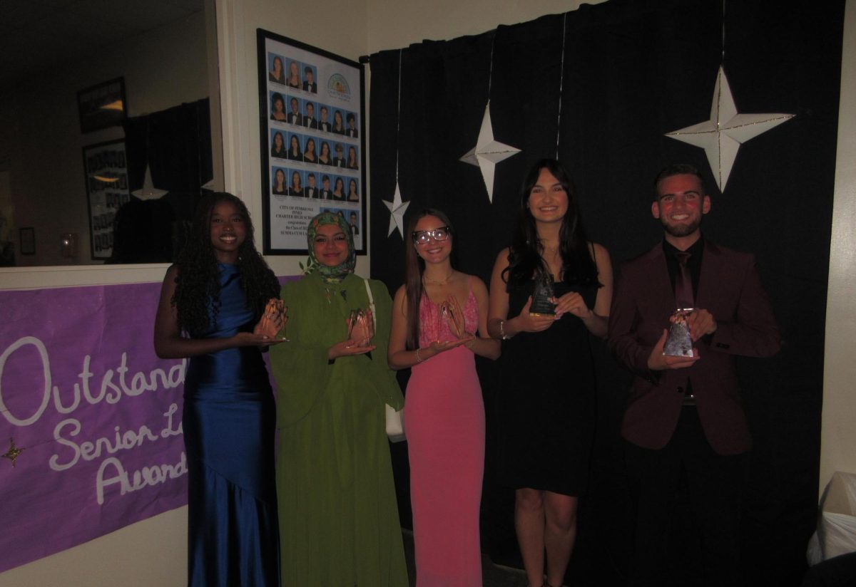 (left to right) Robertzsa Joseph, Asiya Mohammed, Janeyliz Baez, Julianna Perez, and Ryan Perez smile and hold their trophies, honoring their contributions to the school community.