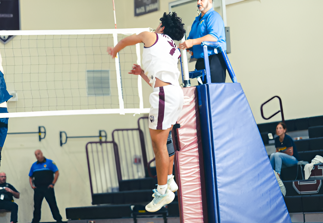 Sophomore Noah Reynolds spiking the volleyball to get the point for the Jaguars. 