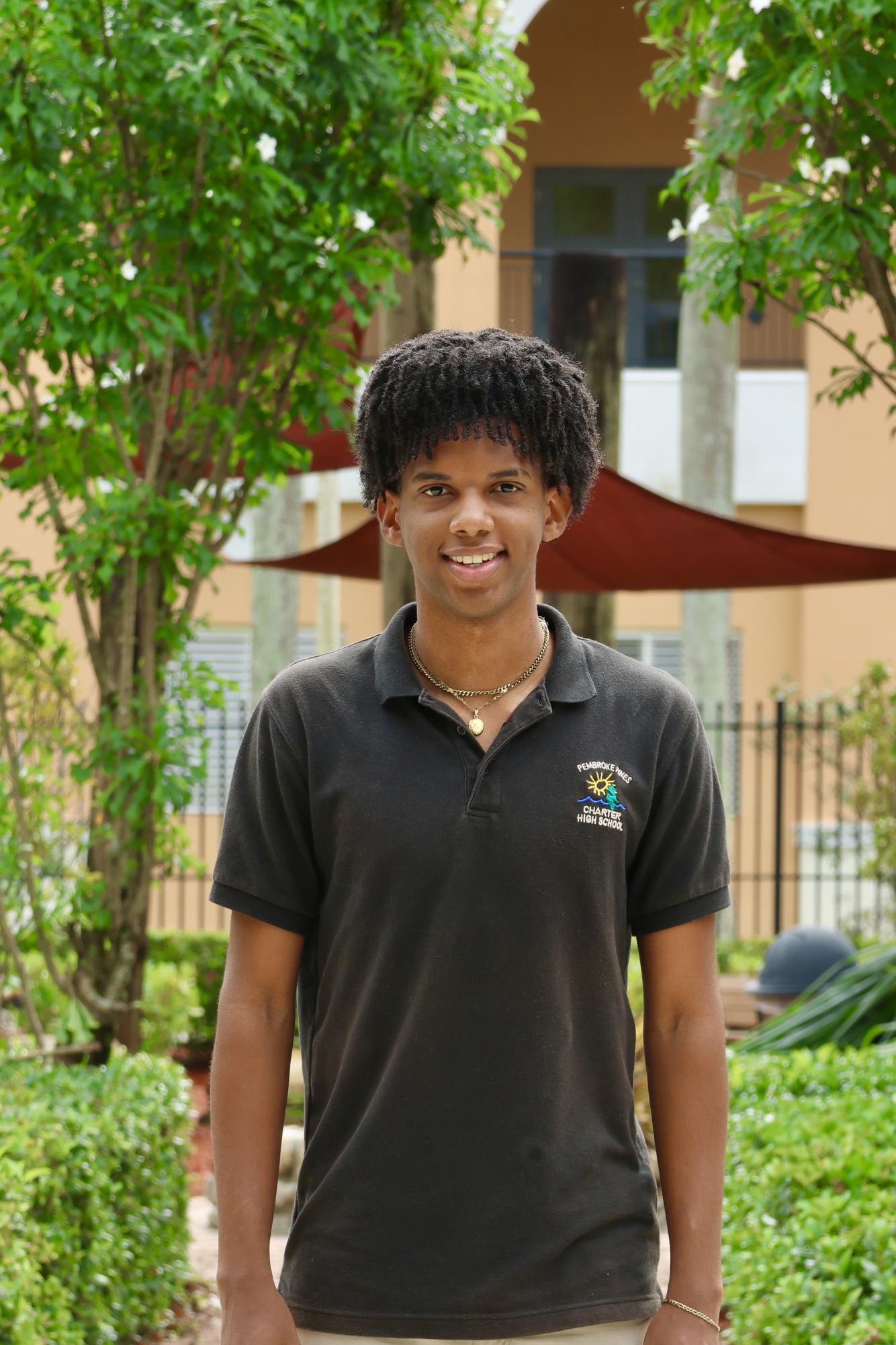 Senior Emmanuel Baptiste smiling at the camera for his CHAT staff picture.