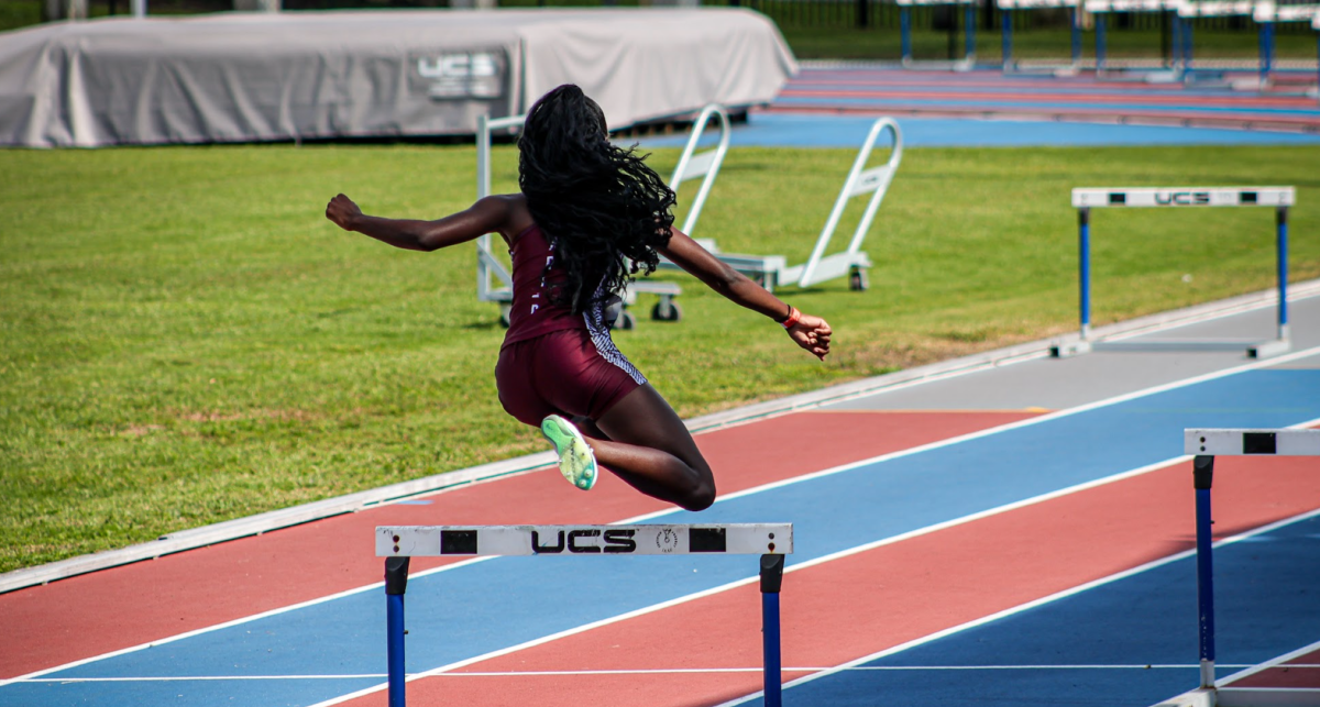 Senior Sarah Rogers jumping the hurdles during a track meet in hopes of getting first place.