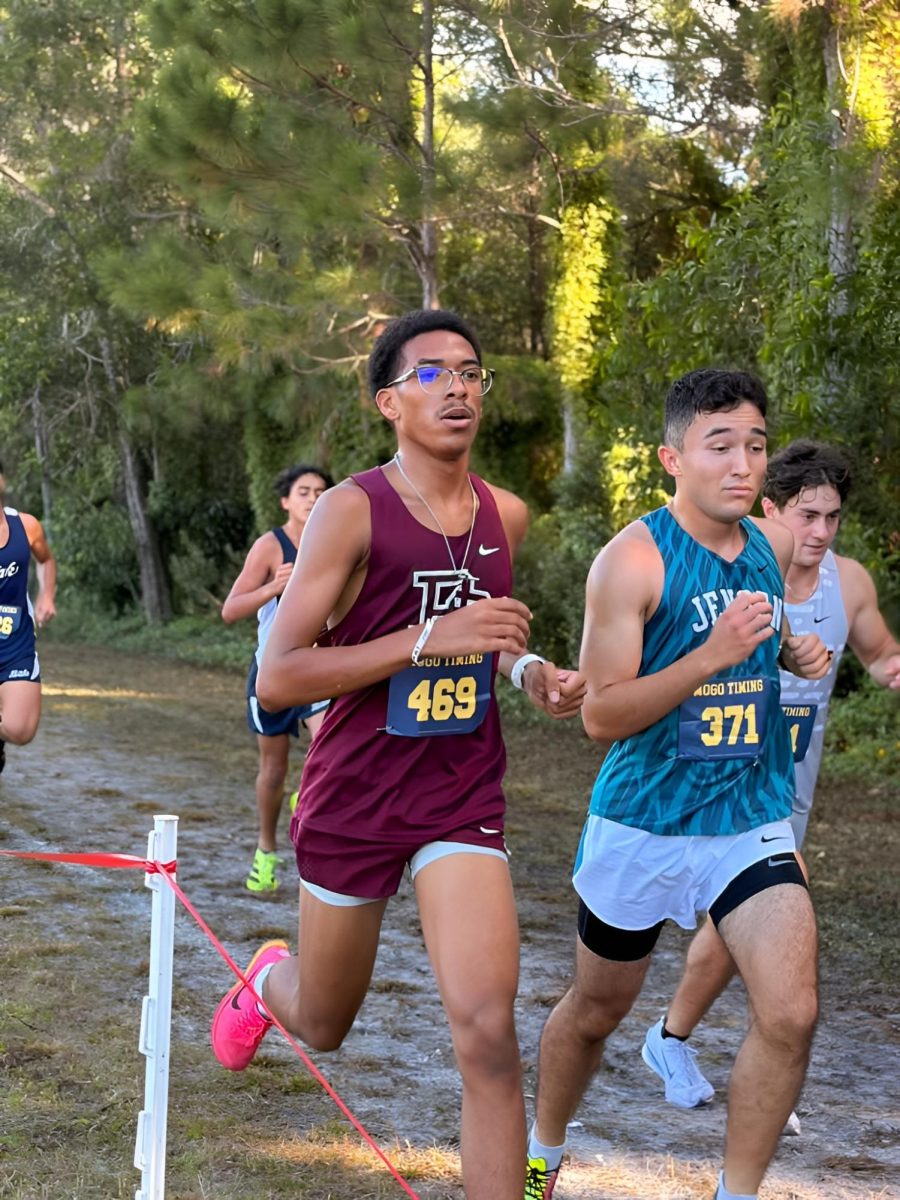 Senior Kameron James on the Jaguars track team races to the finish line during a meet. 