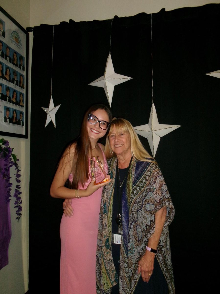 Janeyliz Baez and SGA advisor Nancy Altimore hug and celebrate Baez's work as SGA President.