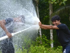 Donated photo from Evan Omana in the Dominican Republic, capturing the lit faces of him and his friends playing with water pipes