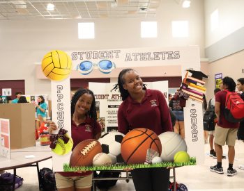 PPCHS's Student Athlete Association created a fun board for new members to take photos in. On the left is Vice-President Adrianna Caldswell and on the right is Historian Brianna Cenatus.