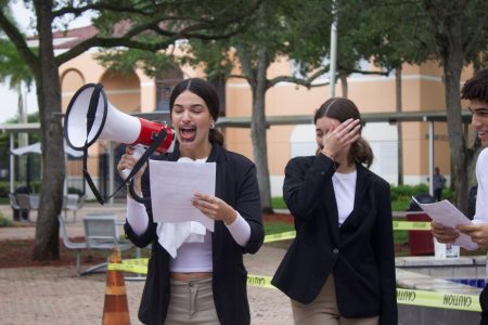 A senior with a hand-painted mustache, in full Founding Father style, reads her assigned portion of the nation's most vital document. Her group partners laugh as she reads through the megaphone.
Photo by: <a href="https://ppchsnews.com/staff_profile/janellie-enriquez/">Janellie Enriquez</a>