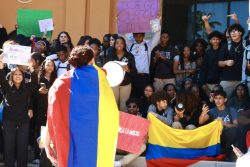 Students wave the Colombian flag in protest of ICE violence.
