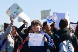 Sophomore Jacob Hladek holds up a sign made of notebook paper, a symbol of last-minute bravery in joining the protest.