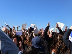 PPCHS students from every grade hold up their hands and posters in protest against ICE's presence in Pembroke Pines and in the US as a whole.
