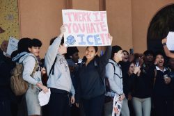 Juniors Landon Moran (left) and Sophia Alan (right) hold a sign, which says "Twerk if you hate ICE".